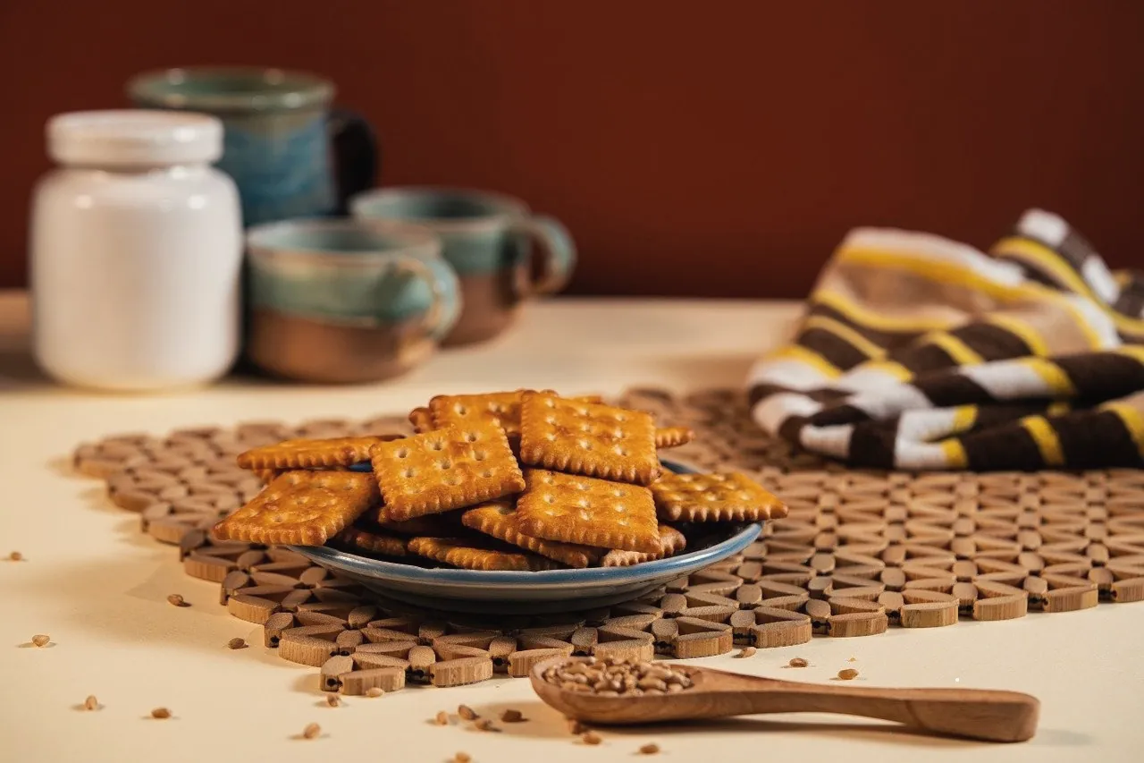 Tea and biscuits laid out on a warm kitchen table