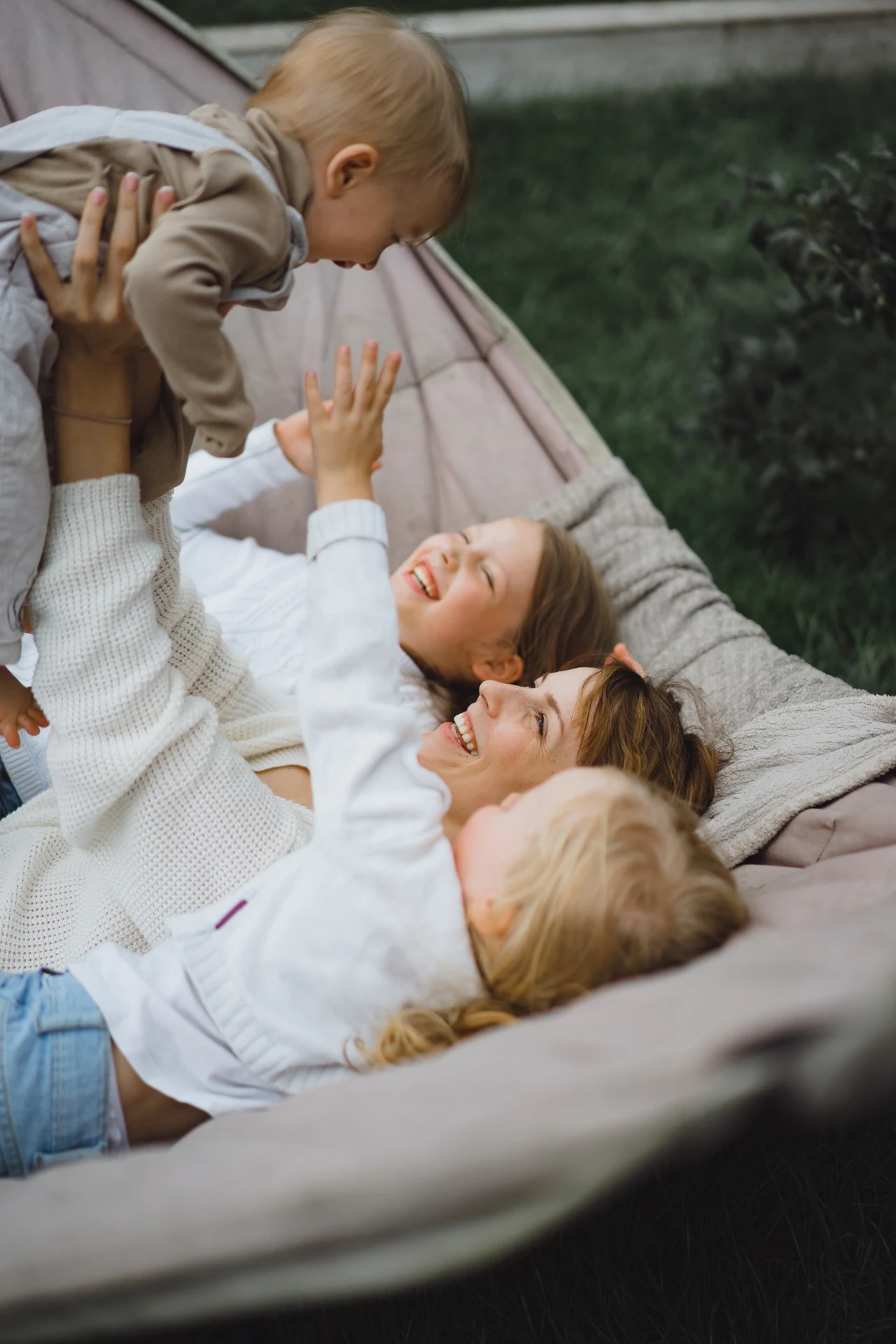 Mother and children relaxing together outdoors