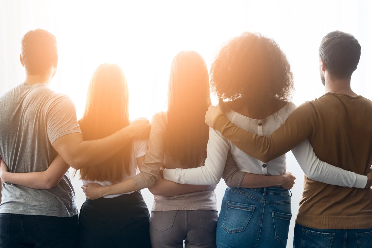 A diverse team standing together in warm natural light