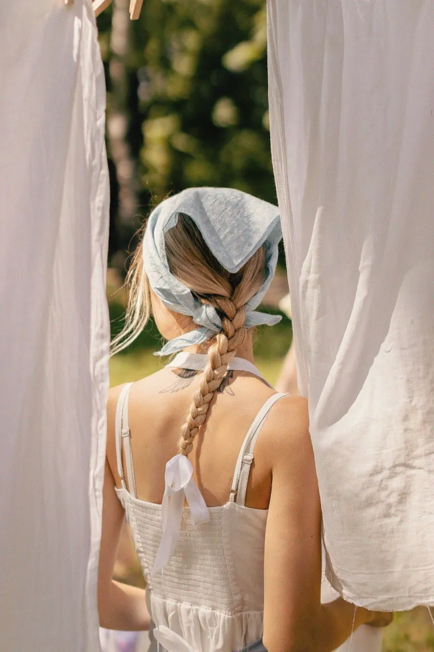 Young person standing between light curtains in a calm room