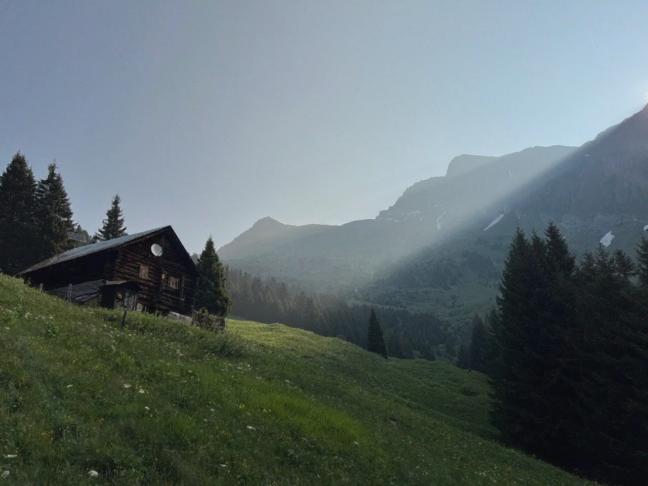 A small house set among green hills